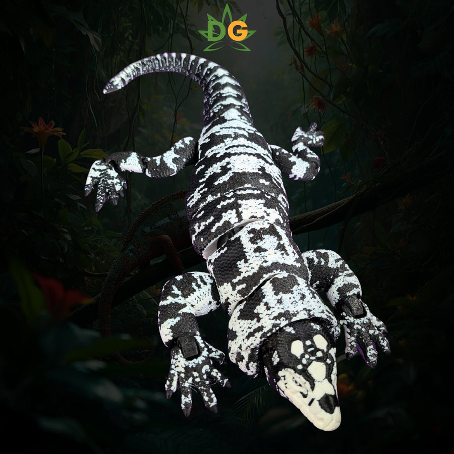 A black-and-white patterned articulated Tegu lizard toy perched on a branch.