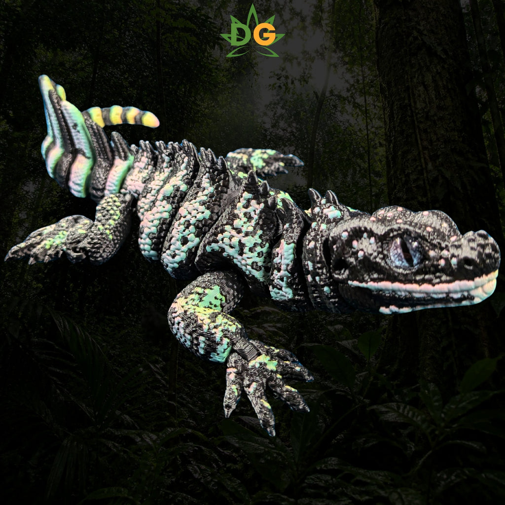 A 3D printed Sailfin Lizard fidget toy with a black, green, and yellow patterned body against a dark forest background.