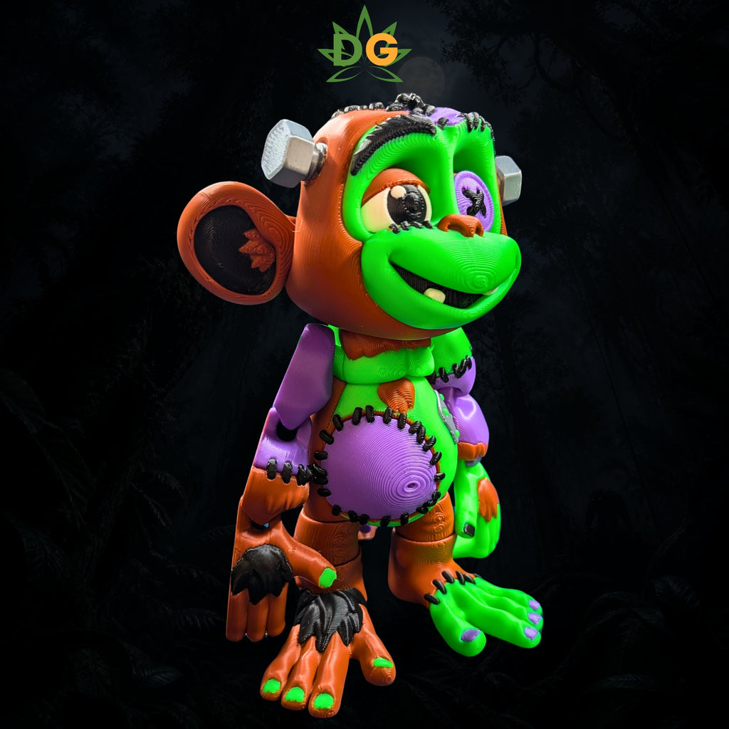 A 3D printed Frankenstein monkey toy with colorful patches, stitches, and metal bolts in its head.