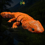 An orange, textured, articulated 3D printed giant salamander toy floats against a dark forest and stream background.