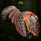 Articulated 3D-printed pangolin sensory fidget toy with black-and-orange scales.