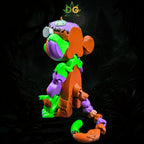 A 3D-printed Frankenstein monkey toy with articulated limbs and visible seams against a dark, jungle-themed background.