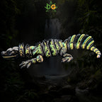 Articulated 3D-printed Sailfin Lizard with a black, green, and yellow patterned body against a jungle waterfall background.