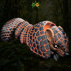 A 3D-printed XL Armadillo flexi figure with black and orange geometric scales, set against a forest background.