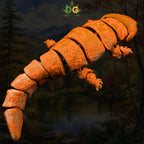 An orange, articulated 3D printed giant salamander figure against a backdrop of a forest lake.