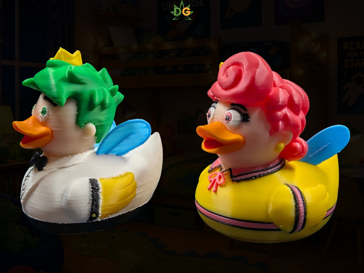 Two 3D printed fairy ducks styled as a male character with green hair and a female character with pink hair.