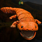 An articulated 3D printed giant salamander toy with an open mouth, set against a dark forest and river background.
