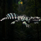 A textured, black and white 3D printed Sailfin Lizard with a striped, spined tail in a jungle setting.